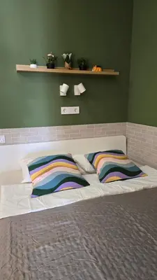 a bed with colorful pillows on it in a room at Arena Legacy Modern Suits in Valencia