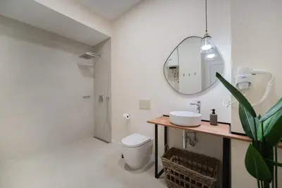 a bathroom with a toilet and a sink and a mirror at Apartments LEON PARE RICO in Valencia