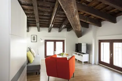a living room with a red chair and a couch at SingularStays San Vicente in Valencia