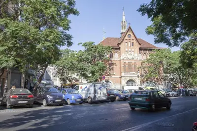 a busy city street with cars parked in front of a building at SingularStays San Vicente in Valencia
