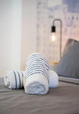 a stack of towels sitting on a floor at Apartamento Ciudad de las Ciencias con Terraza in Valencia
