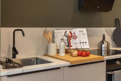 a kitchen counter with a sink and a cutting board with vegetables at SariStays Valencia Modern & O in Valencia