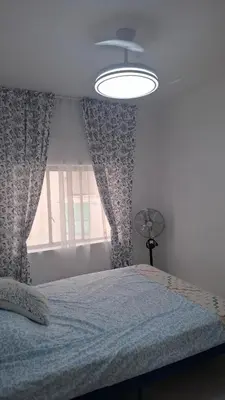 a bedroom with a bed with a ceiling fan and a window at 3 bedroom apartment with a terrace 50 steps from the Nules beach in Mascarell