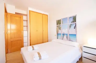 a bedroom with two beds and a window with the beach at TODO INCLUIDO - Wifi,playa,piscina 24h,garaje,terraza y Mercadona -MUY CÓMODO in Canet de Berenguer