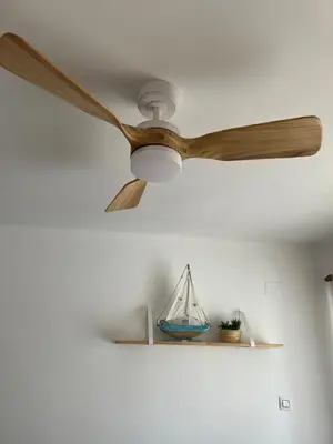 a ceiling fan with a boat on a shelf at District Key - Puerto de Sagunto, Asturias in Puerto de Sagunto