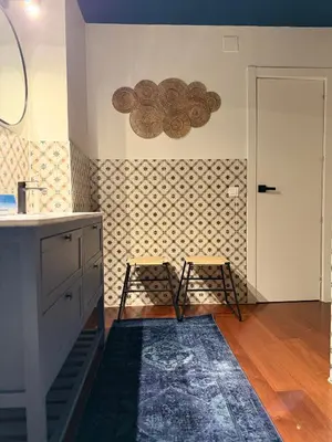 a kitchen with two stools next to a wall at Trendy Ruzafa Neighborhood - Spacious Luxury 3BR with Double Terrace in Valencia