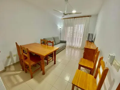 a living room with a table and chairs and a couch at LAS LANZAS II - ATF Turisferr in Tavernes de Valldigna