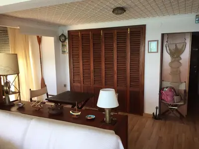 a bedroom with a bed and a desk with a lamp at Fantásticas vistas al mar en el Faro in Faro de Cullera