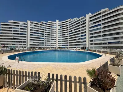 a large building with a large swimming pool in front of it at Résidence El Prado in Cullera