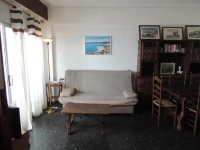 a living room with a white couch and a table at Résidence El Prado in Cullera