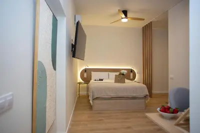 a hotel room with a bed and a ceiling fan at Nomad Haux Zaidia in Valencia