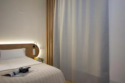 a bedroom with a bed with a camera on it at Nomad Haux Zaidia in Valencia