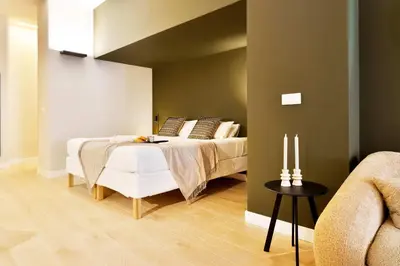 a bedroom with a bed and a table with two candles at SariStays Valencia City Center R in Valencia
