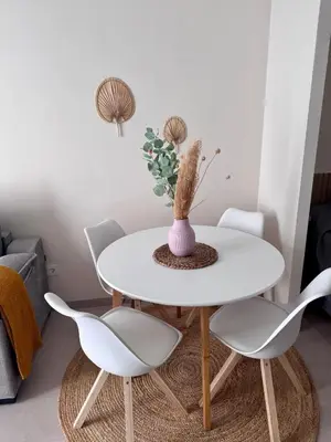 a white dining room table with white chairs and a vase at Apartamento Boutique Valencia 4-Pax - A-1 in Valencia
