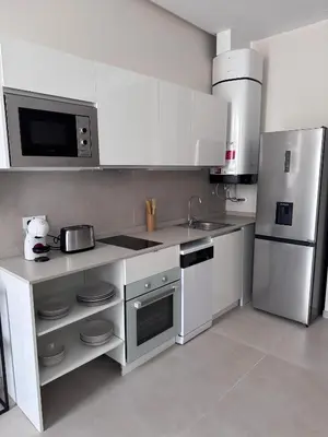 a white kitchen with a sink and a refrigerator at Apartamento Boutique Valencia 4-Pax - B-2 in Valencia
