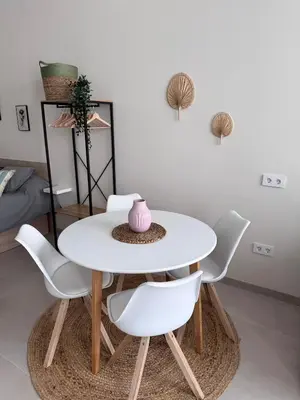 a white table with white chairs and a pink vase at Apartamento Boutique Valencia 4-Pax - B-2 in Valencia