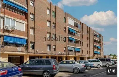 a parking lot with cars parked in front of a brick building at Habitaciones en Apartamento Port Sagunto in Puerto de Sagunto