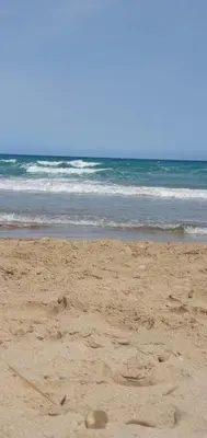 a sandy beach with some footprints in the sand at Habitaciones en Apartamento Port Sagunto in Puerto de Sagunto