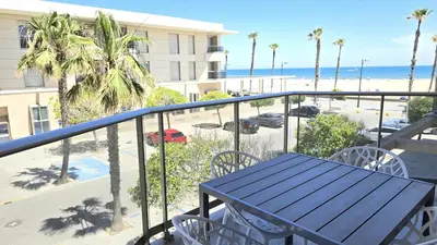 a balcony with a table and a view of the beach at BEACH VALENCIA LUXURY A36-22 Apartment with terrace and sea views in Valencia