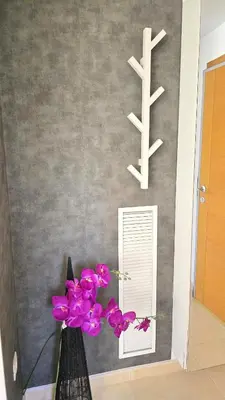 a vase with purple flowers in front of a mirror at BEACH VALENCIA LUXURY A36-22 Apartment with terrace and sea views in Valencia