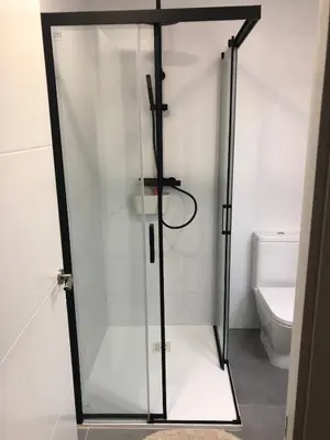 a glass shower door in a bathroom with a toilet at Apartamento con vistas a la playa in El Perelló