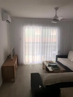 a living room with a couch and a coffee table at Apartamento con vistas a la playa in El Perelló