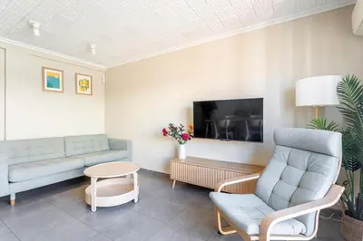 a white bedroom with a white bed and a lamp at GuestReady - Your Relaxing Base in Valencia in Valencia