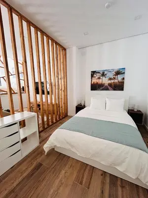 a bedroom with a large bed and a desk at Aires de Valencia in Valencia
