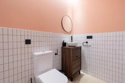 a bathroom with a toilet and a mirror on the wall at Blue City Apartments in Valencia