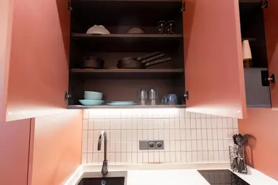 a kitchen with orange cabinets and a sink at Blue City Apartments in Valencia