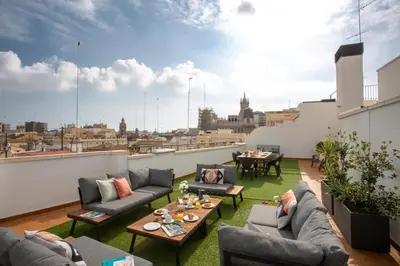 a patio with couches and tables on a roof at SingularStays Mar44 Terrace in Valencia