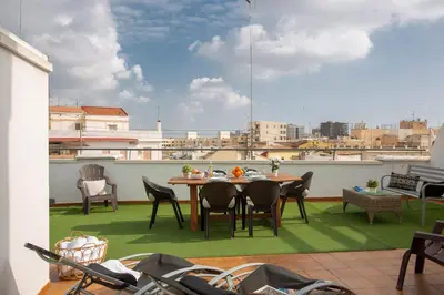 a patio with a table and chairs on a balcony at SingularStays Mar44 Terrace in Valencia