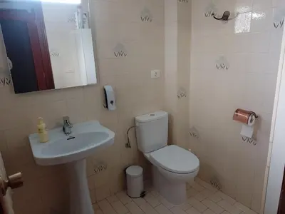 a bathroom with a toilet and a sink and a mirror at Casa Numari in Caudiel