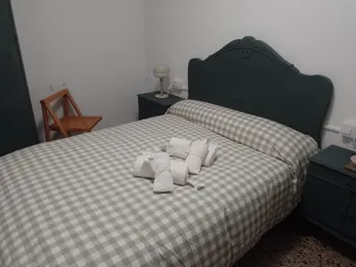 a bed with white pillows on top of it at Casa Numari in Caudiel