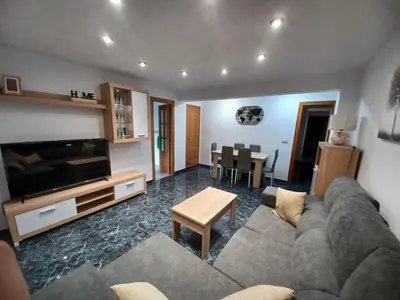 a living room with a couch and a table at piso tres habitaciones in Valencia