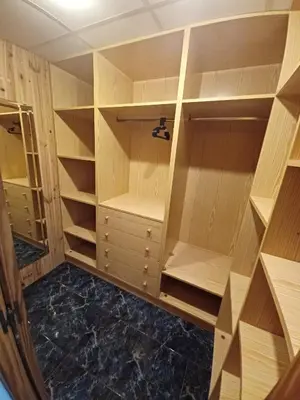 a walk in closet with wooden shelves at piso tres habitaciones in Valencia