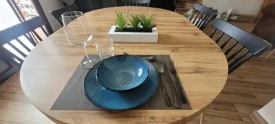 a wooden table with a blue plate on top of it at Casa Los Yayos in Segorbe