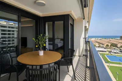 a balcony with a table and chairs and a view of the ocean at Valencia Beach Home 21 in Valencia