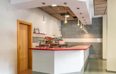 a kitchen with a red counter in a room at Hotel Alba in Puzol