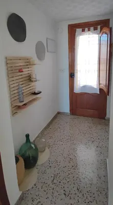 a room with a door and a vase on the floor at San Juan in Alborache