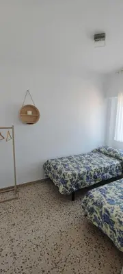a room with two beds and a lamp in it at San Juan in Alborache