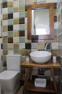 a bathroom with a sink and a toilet and a mirror at Playa Cabañyal - Diseño Mediterraneo in Valencia
