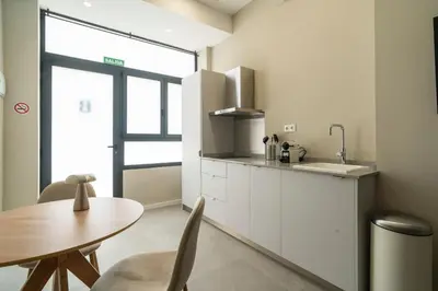 a kitchen with a table and a sink at VLC Host - Sumsi Studios in Valencia