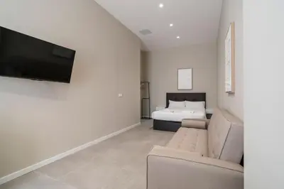 a living room with a couch and a bed at VLC Host - Sumsi Studios in Valencia