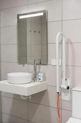 a bathroom with a sink and a mirror on a wall at VLC Host - Sumsi Studios in Valencia