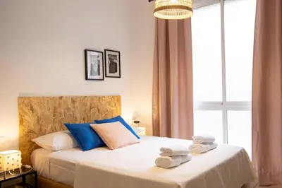 a bedroom with a bed with towels on it at LObjet trouvé in Valencia
