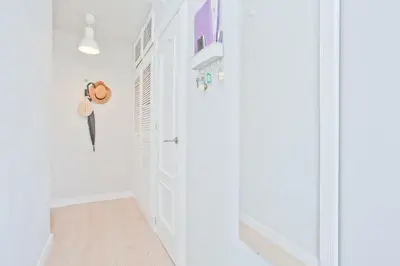 a hallway with white walls and a white door at El Cabanyal - Mar y Atardecer in Valencia