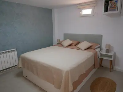 a bedroom with a bed and a small table at Natural park, terrace and pool in Partida de La Cañada