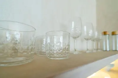 a row of empty glasses sitting on a counter at Nomad HAUX Puerto in Valencia