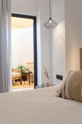 a bedroom with a bed and a view of a patio at Stylish downtown charm in Valencia